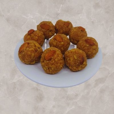 Annamayya Laddu symbolizes devotion and spirituality with its connection to the renowned poet and the spiritual atmosphere of the temple